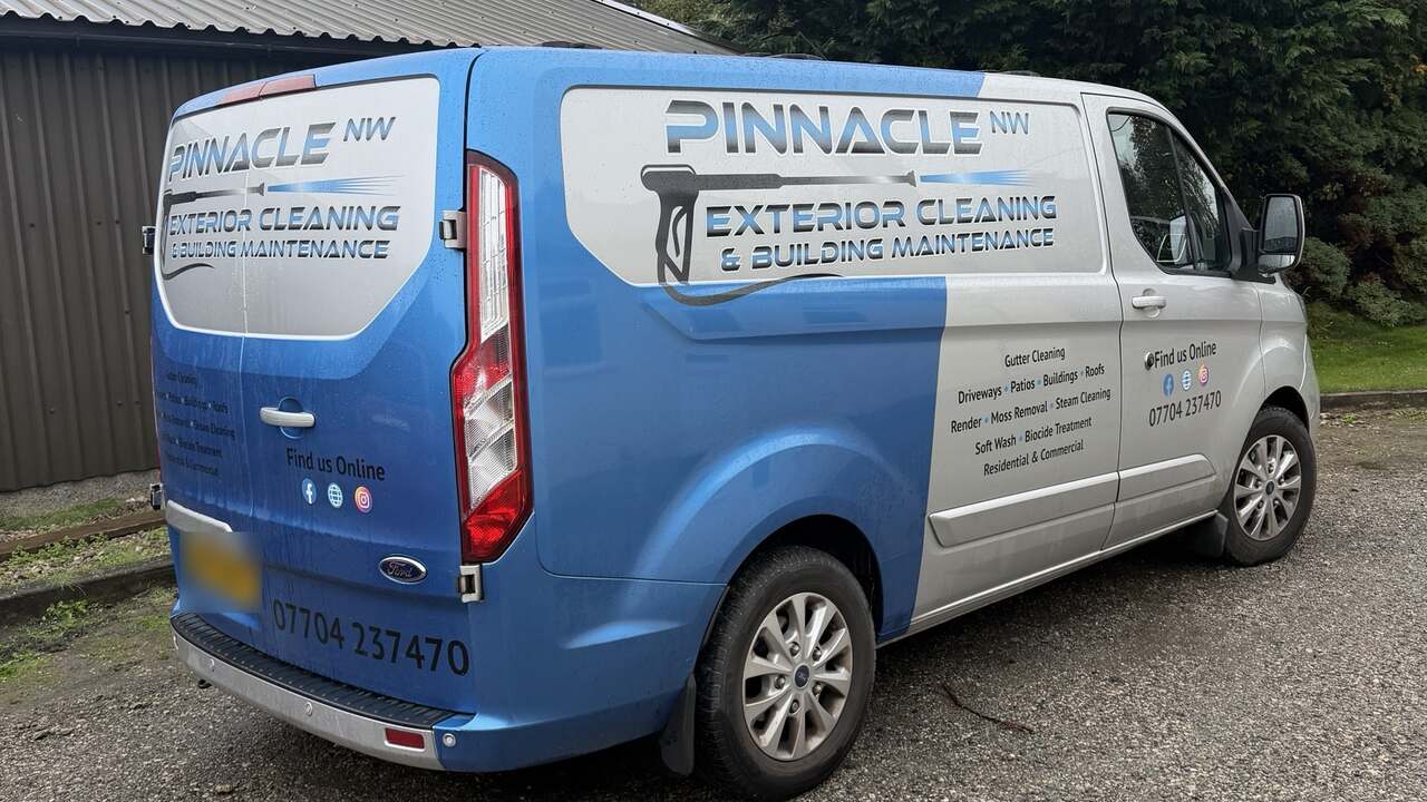 The Pinnacle NW van in blue and silver livery, parked on gravel