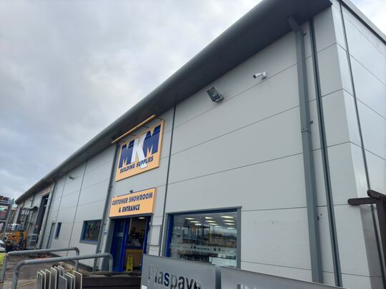 Grey cladding and entrance of a builders' merchant after cleaning
