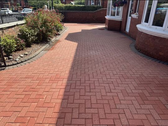 After: red herringbone block-paved front drive outside a red brick house