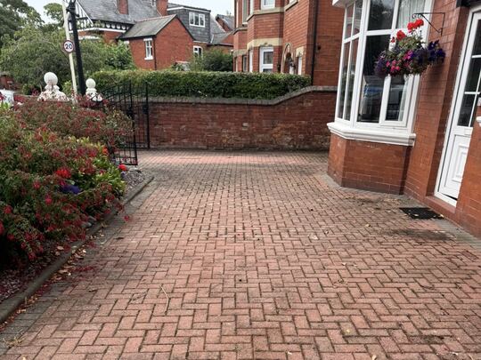 Before: red herringbone block-paved front drive outside a red brick house