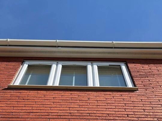 After: white uPVC fascia and soffit above a window