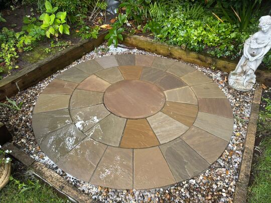After: circular stone patio in a garden