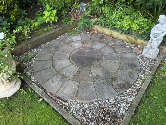 Before: circular stone patio in a garden