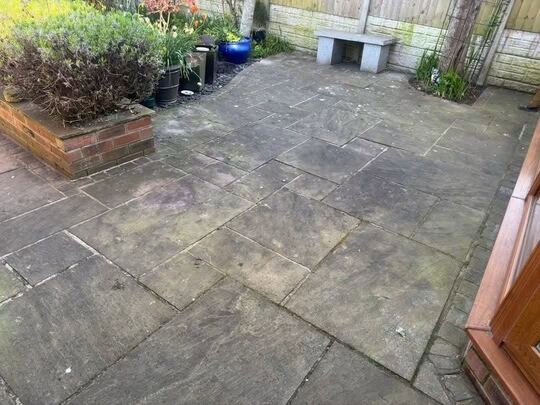 Before: sandstone patio by a conservatory