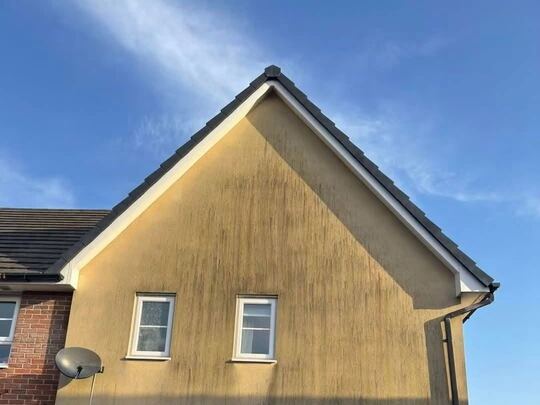 Before: rendered house wall