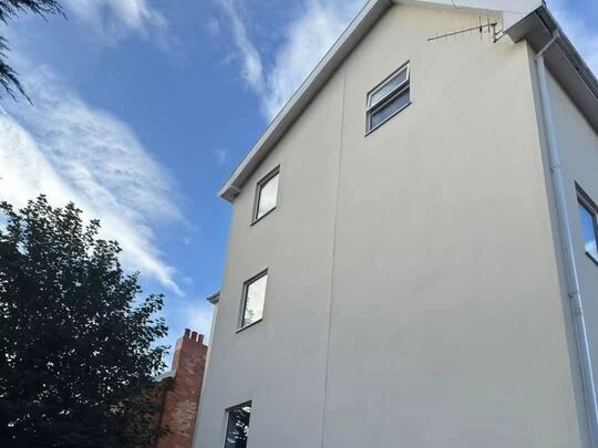 After: three-storey rendered house
