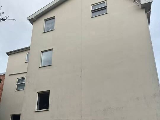 Before: three-storey rendered house